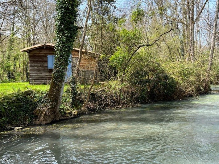 Fisherman's Dream. Leisure Plot On The River With Small Wood Cabin